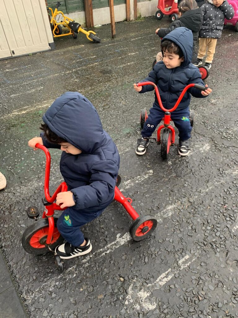 Two childrens playing with bicycle